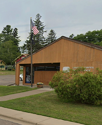 Askov Post Office with American flag, symbolizing community service.